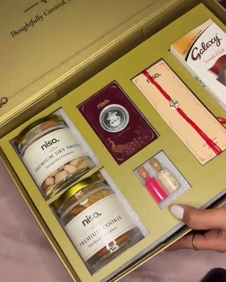 NISO Rakshabandhan gift hamper with 1.5 g 925 silver Rakhi, 1 g 999 silver coin, chocolate, premium dry fruits, cookie jar, kumkum and chawal