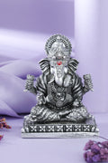 Silver seated Ganesha idol with lotus buds