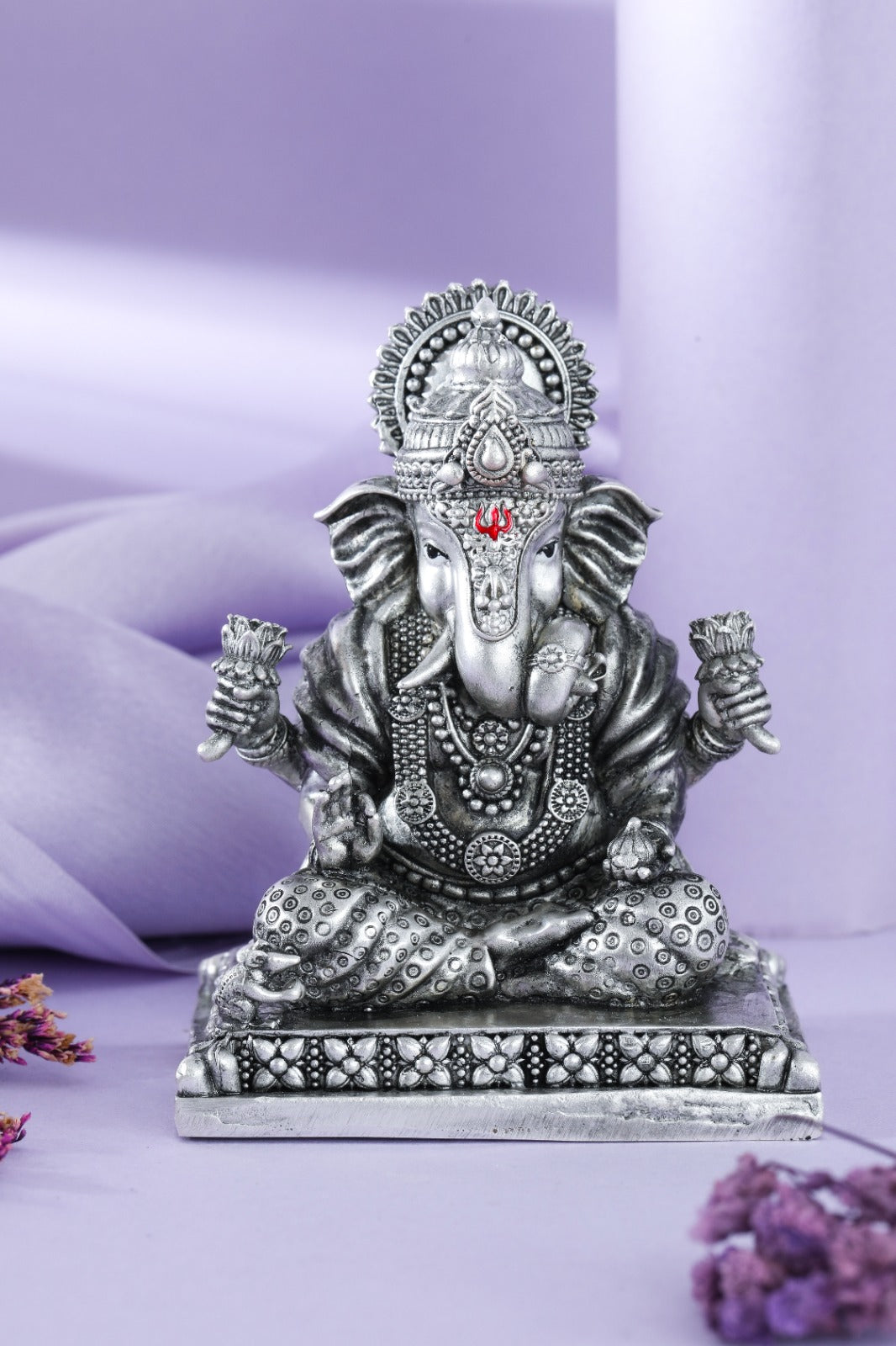 Silver seated Ganesha idol with lotus buds