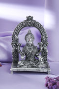 Silver-tone Goddess Lakshmi idol with lotuses and coin bowl